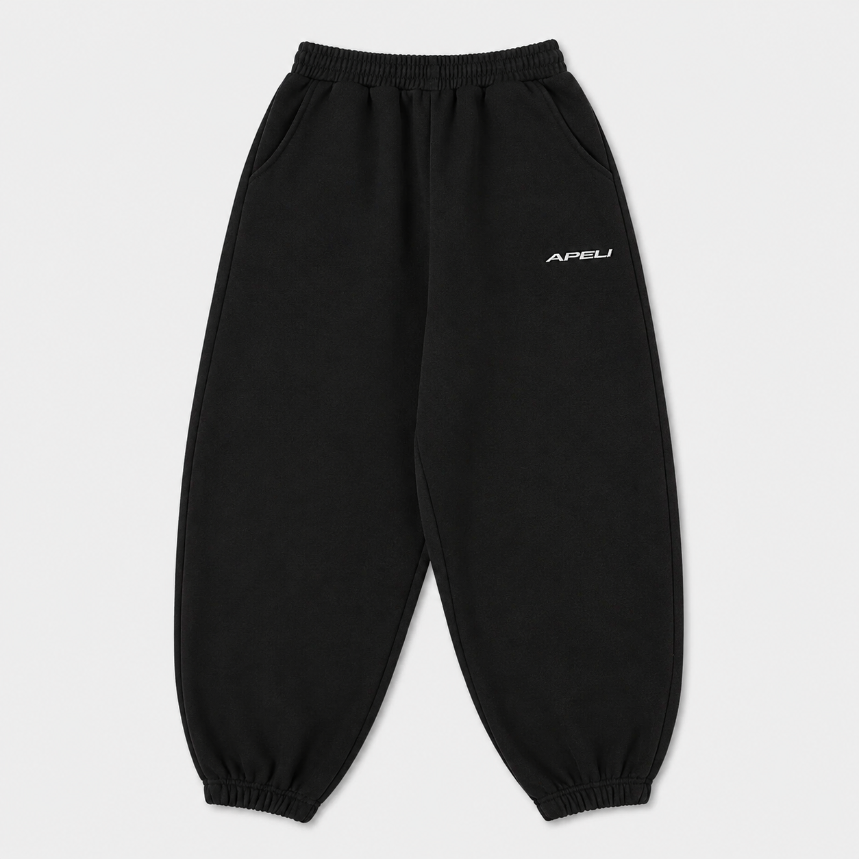 Black sweatpants with a brand logo on a light gray background